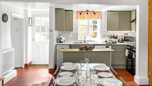 A modern kitchen with a dining area set for six.