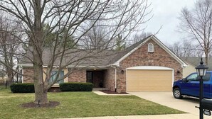 A single-story brick house with a garage, a lawn, and a tree in the front yard. - Newly renovated 1400 Square Foot 3 Bedroom Home. (Indianapolis,)