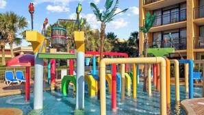 A water park area with colorful play structures and a pool. - Beautiful Ocean Views, on 15th floor! (Myrtle Beach)