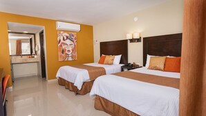 A hotel room with two beds, a bathroom, and a painting on the wall.