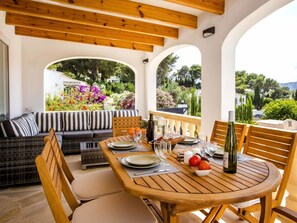 Enjoy al fresco dining in this serene garden setting, complete with a beautifully set table for two.