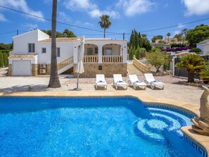Relax by the serene pool surrounded by lush greenery and a beautifully maintained garden.