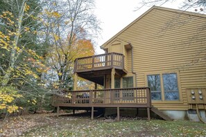 A two-story building with a balcony and a deck.