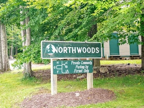 A sign for Northwoods Private Community Parking, indicating a permit-only parking area. - Northwoods F2 - Walk-to-Slope, Remodeled 2025 (Davis)