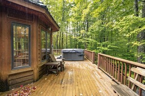 A wooden deck with a hot tub and a chair, surrounded by a forest. - Family Escape w/ Hot Tub & Rec Room - Mtn Nights (Davis)