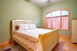 A bedroom with a bed, a window with curtains, a nightstand, and a dresser. - Deer Walk - Private Pond, Access to Dolly Sods (Davis)