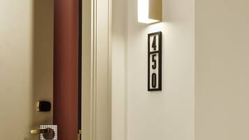 A hotel room entrance with a door, a 'QUIET' sign, and a wall-mounted number sign '450'.