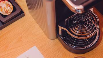 A coffee machine with a menu on the table.