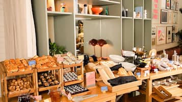 A bakery display with various baked goods and condiments.