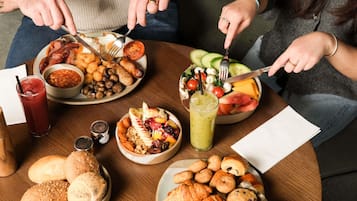 A table with various food items including bread, pastries, and a salad.