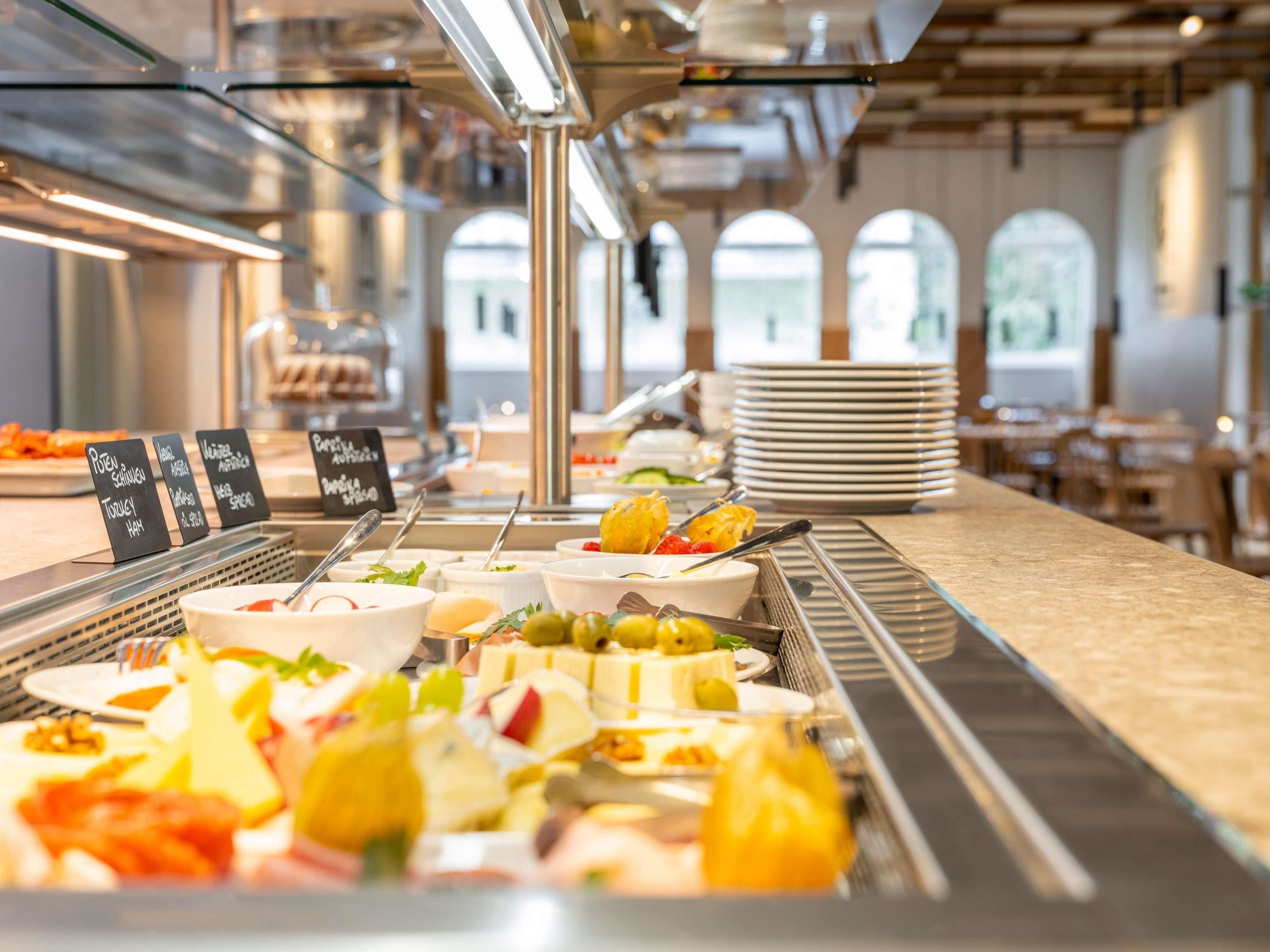 A buffet with various food items and a sign indicating the type of food.