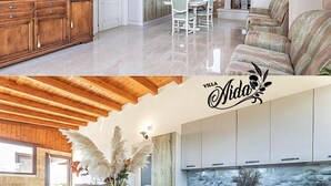Intérieur moderne d’une villa comprenant un coin repas, une cuisine et un espace de vie.