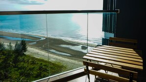 A balcony with a view of a beach and ocean. - Timurbay beachfront by Perfect Host (Kuantan)