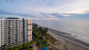A high-rise hotel with multiple balconies overlooking a beach. - Timurbay beachfront by Perfect Host (Kuantan)