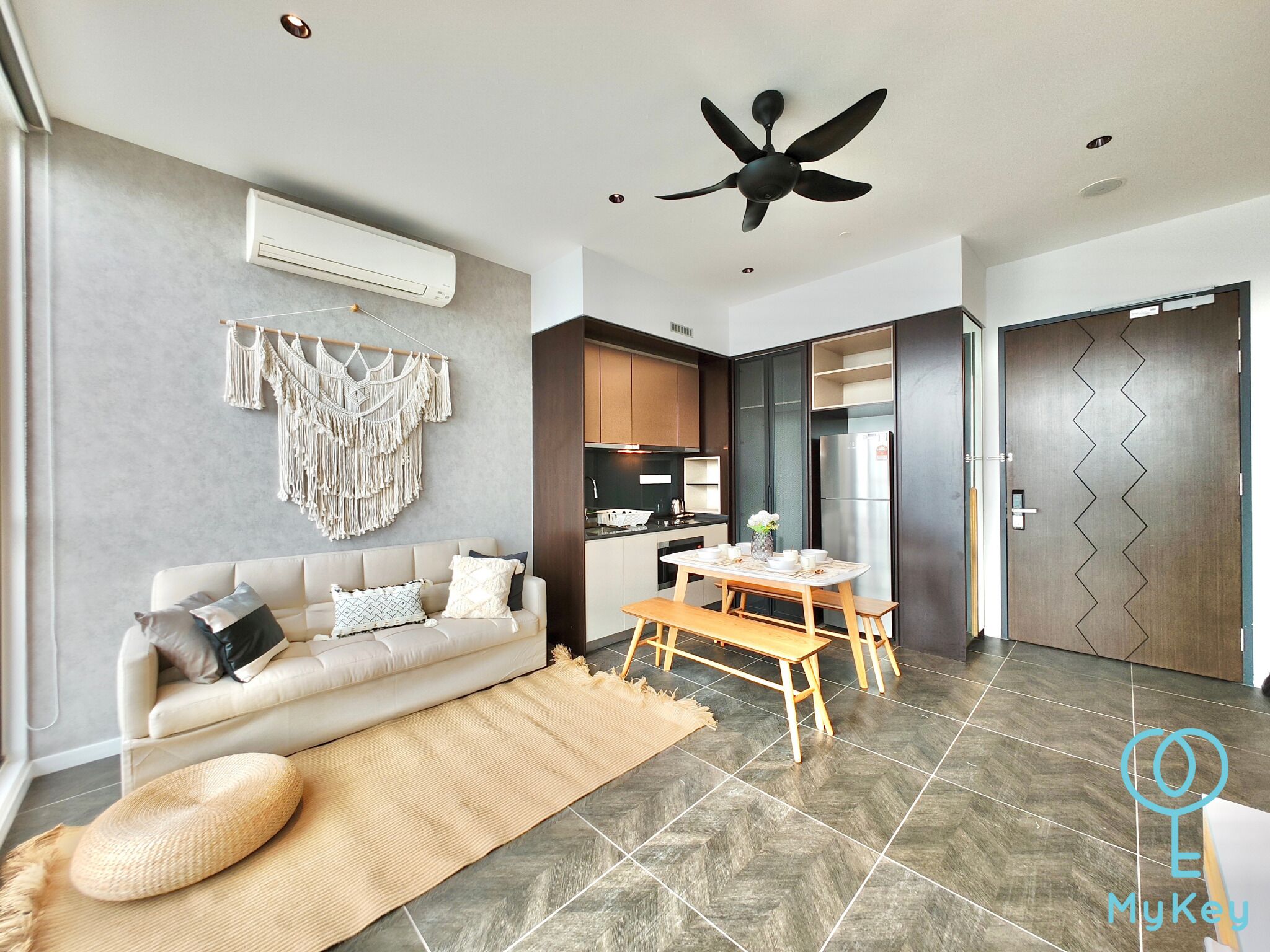 A modern living room with a sofa, a coffee table, and a dining table.
