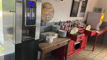 A coffee station with a Follet coffee machine, a Krea Necta espresso machine, and a breakfast sign.