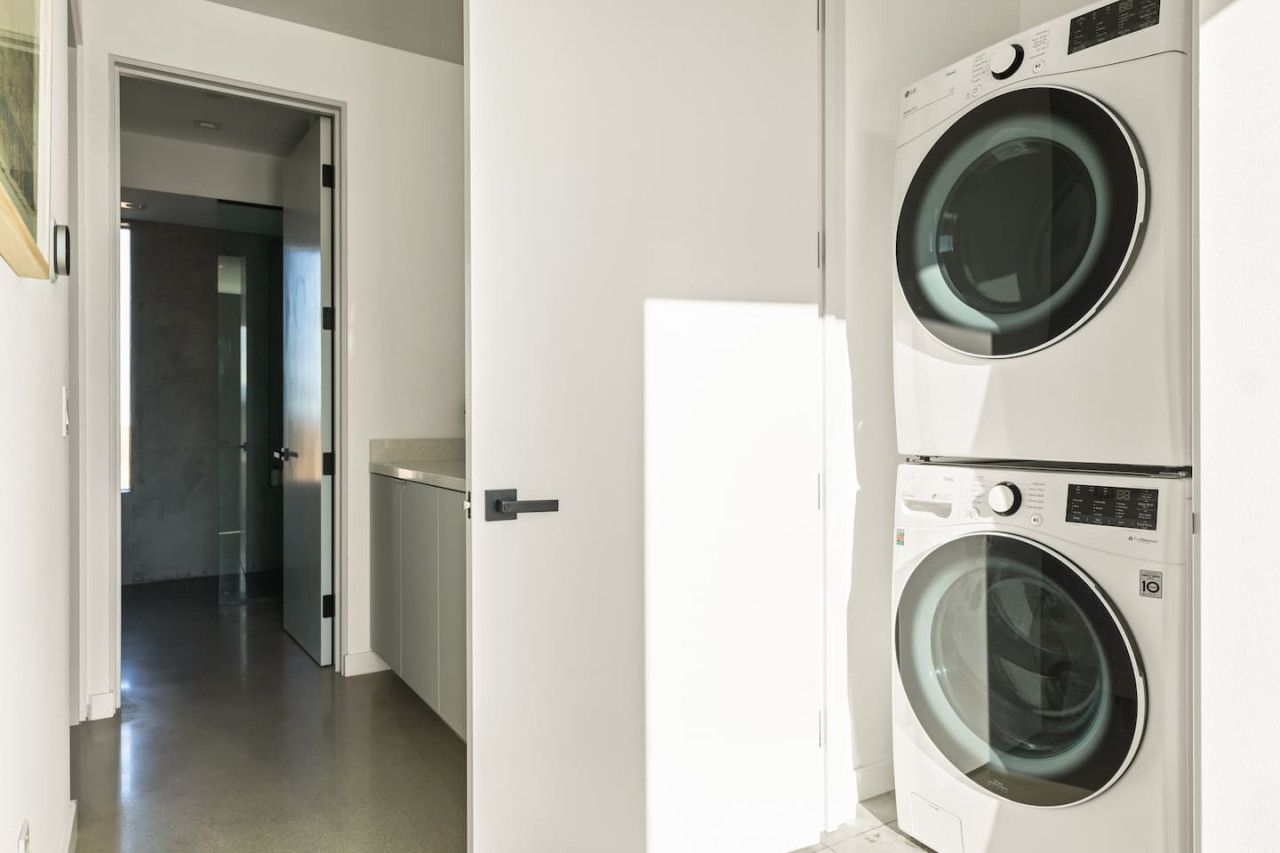 A laundry room with two stacked front-loading washing machines.