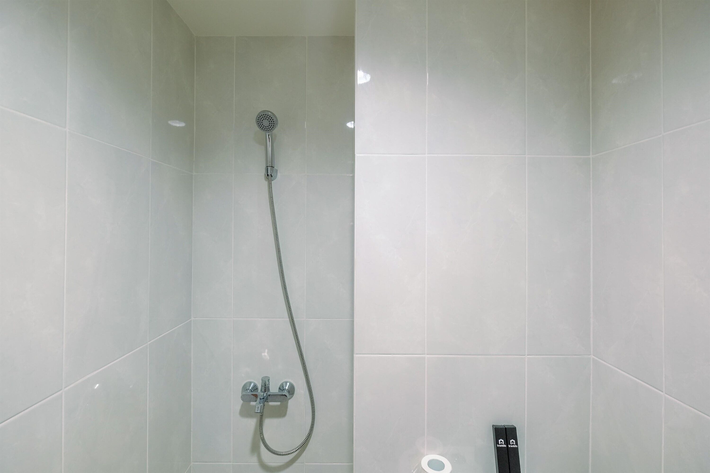 A modern bathroom with a shower, a toilet, and a bidet.