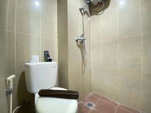 Bathroom features a toilet, shower area, and handheld shower attachment.