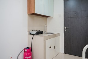 Compact kitchen area with sink and gas stove.