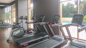 A gym with treadmills, ellipticals, and a rowing machine.