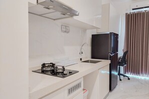 Apartment | Private kitchen | Fridge, cookware/dishes/utensils - Homey Studio Room At Sky House Bsd Apartment (Pagedangan)