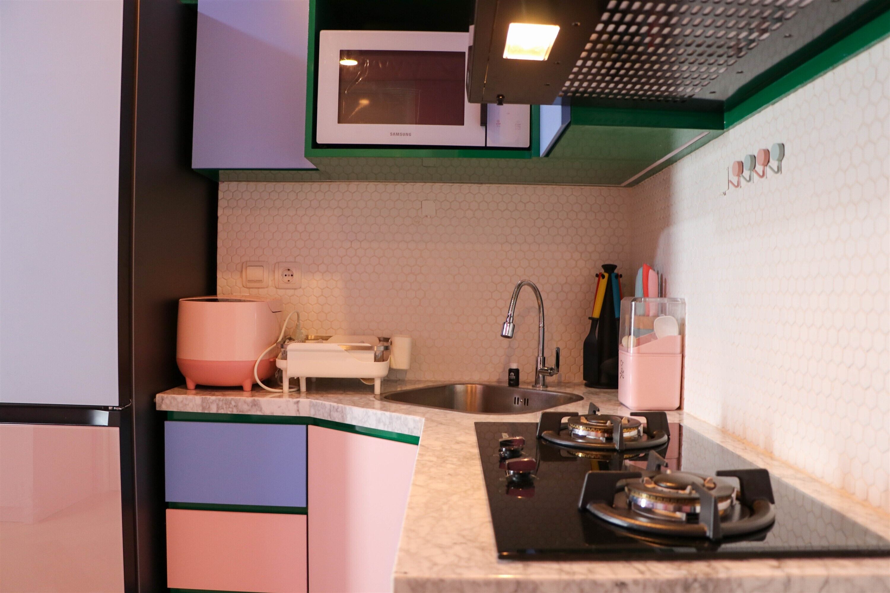 A modern kitchen with a microwave, sink, and gas stove.