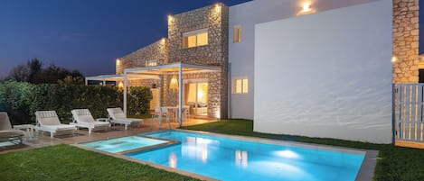 Relax by the outdoor pool surrounded by lounge chairs and a covered patio.