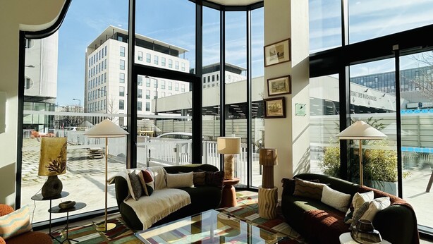 A modern living room with large windows, a colorful rug, and contemporary furniture. - Residhome Quai d'Ivry (Ivry-sur-Seine)