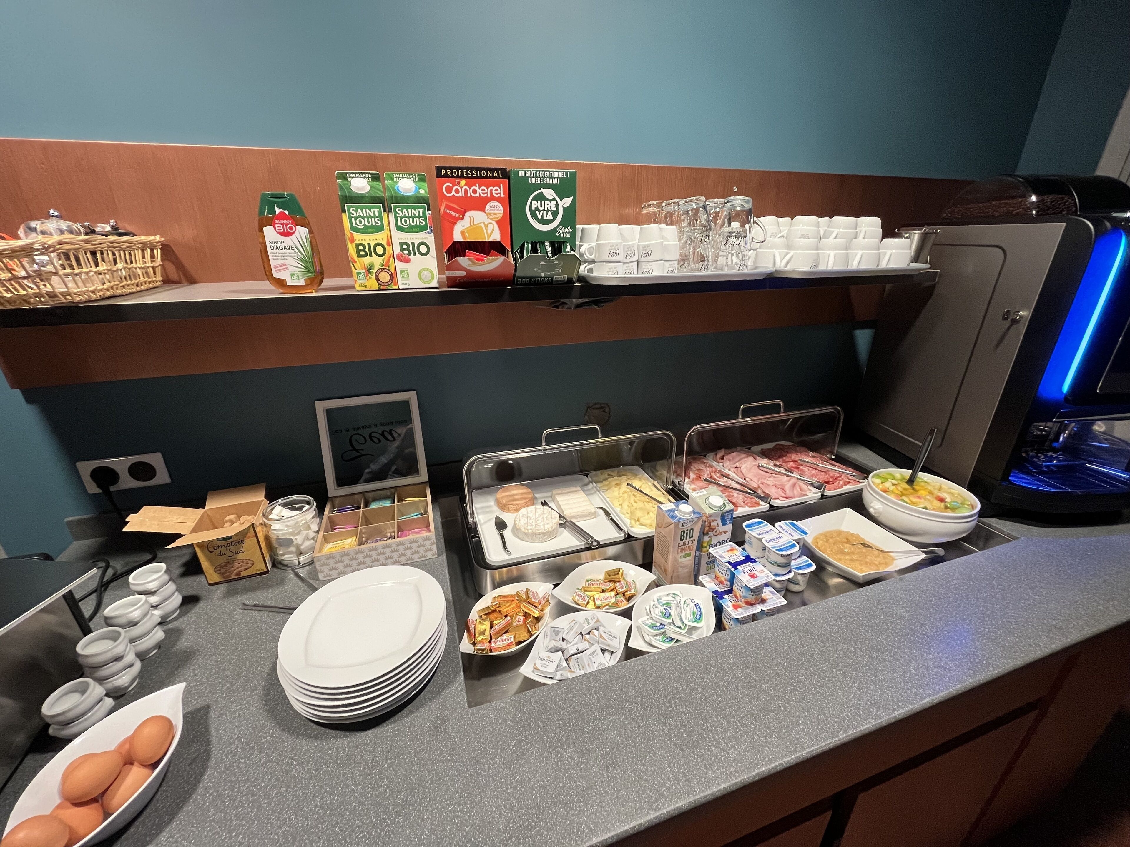 A breakfast buffet with various food options, including cereals, dairy products, and meats.