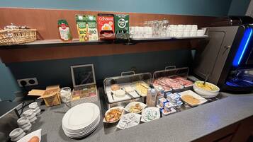 A breakfast buffet with various food options, including cereals, dairy products, and meats.