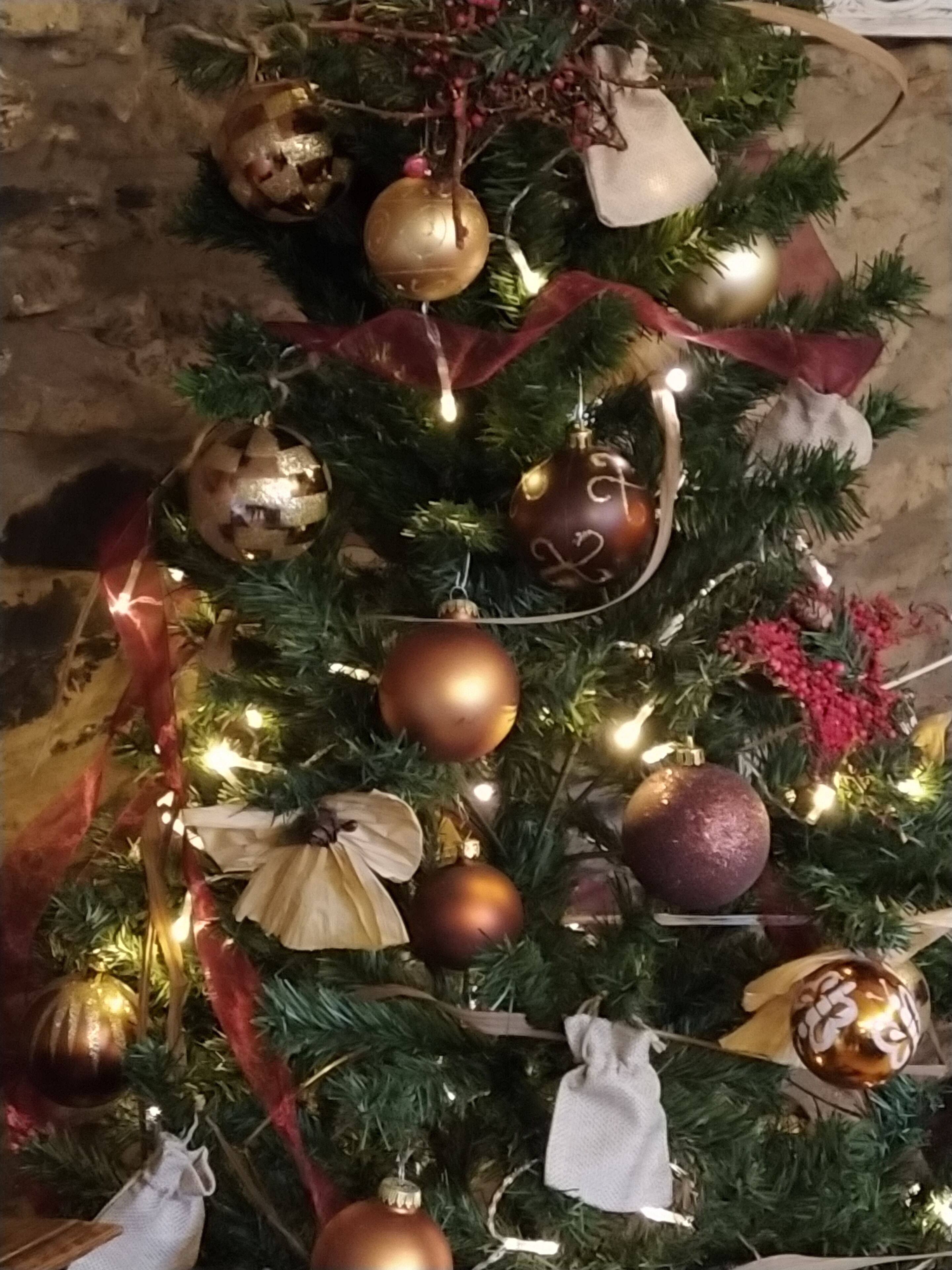 A Christmas tree with various ornaments and lights.