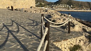 A stone pathway leading to a historic fort, with a clear view of the sea and a hilly landscape in the background. - Holiday Villa Moraira with private heated pool in walking distance to beaches (Moraira)