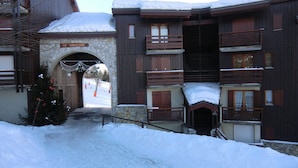 A snow-covered building with a stone archway labeled "LE CHRISTIANA."