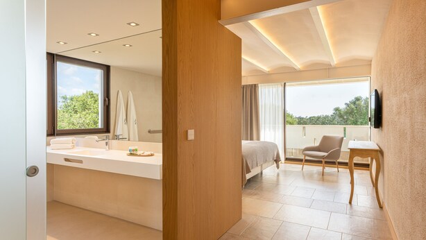A modern bathroom with a large window, a built-in sink, and a shower area. - Agroturismo Malbuger Nou - Adults only (Mahón)