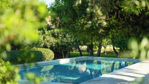 A rectangular swimming pool surrounded by lush greenery and trees. - Agroturismo Malbuger Nou - Adults only (Mahón)