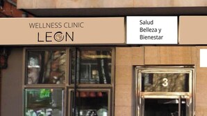 A building facade with a sign reading 'WELLNESS CLINIC LEON' and a glass door with the number '3' above it. - León Apartments. 20 years of success. Centrally located and recently air-conditioned (León)