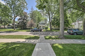 Stroll through a charming residential neighborhood lined with mature trees and single-family homes.