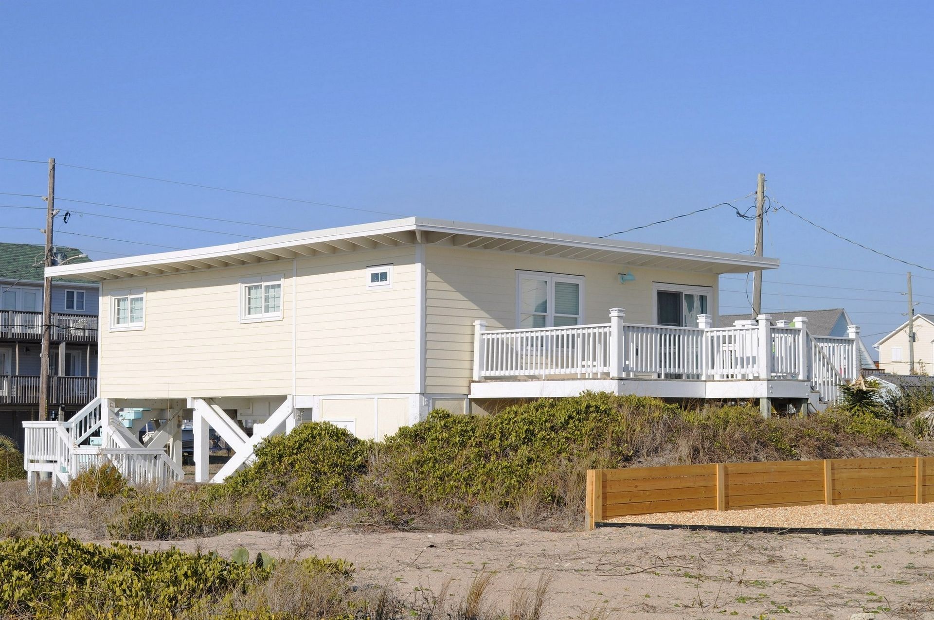 A single-story house with a front deck and a small porch.