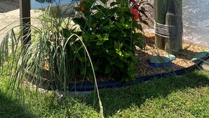 A sign for 'Sugar Dunes' at 1448 Tina Drive, featuring a bird sculpture and surrounding greenery. - Welcome to Your New "HAPPY PLACE"   on your Island get away! (Navarre)