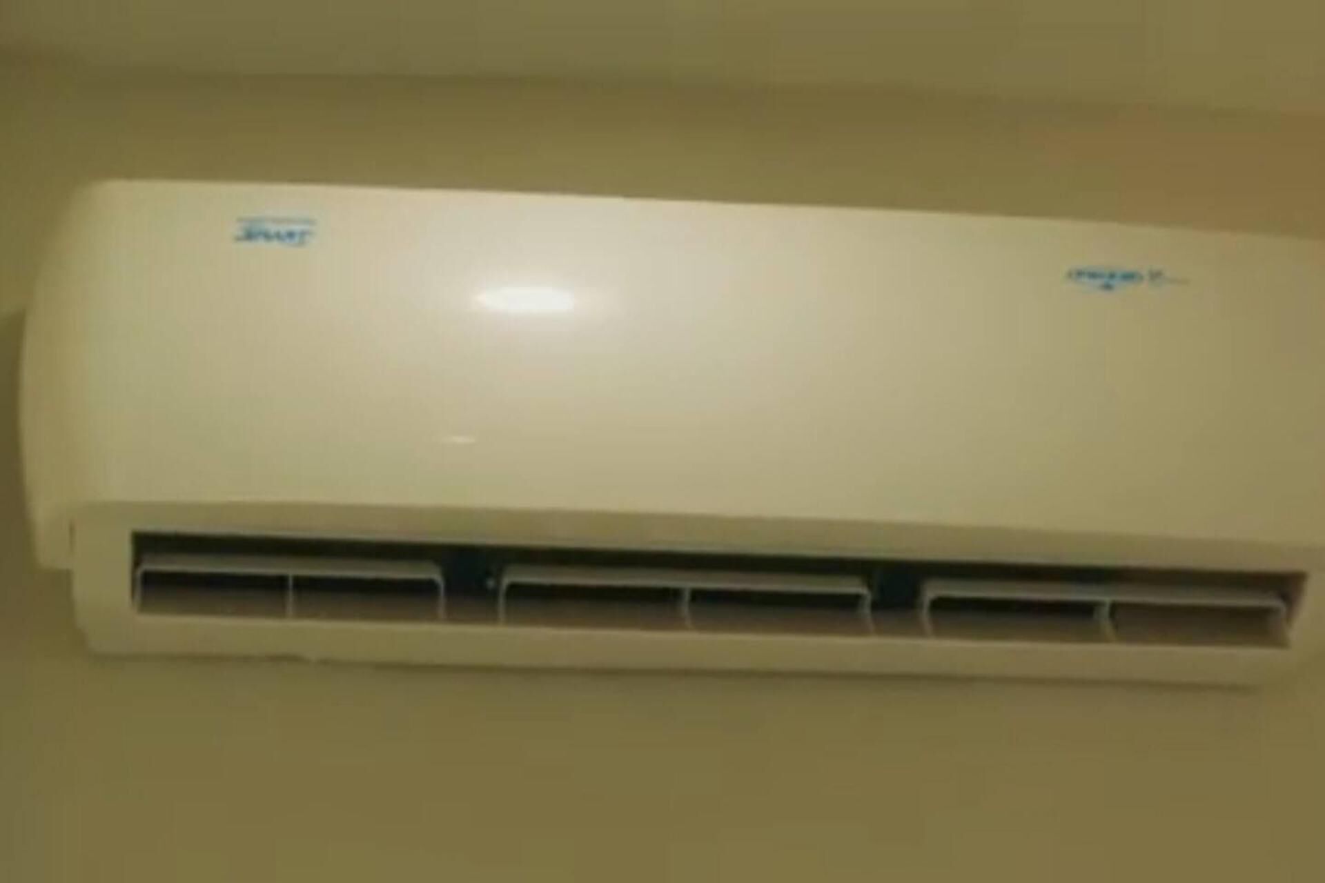A white air conditioning unit mounted on a wall.