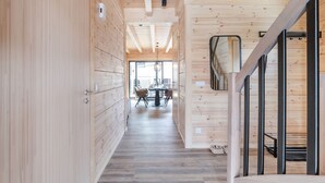 A wooden interior with a central dining area and a staircase. - Bergwaldchalets Wellness (Wernigerode)