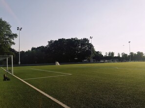 A soccer field with goalposts, floodlights, and a small building in the background. - Private room in a charming bed-and-breakfast, 10 minutes from Copenhagen (Gentofte)