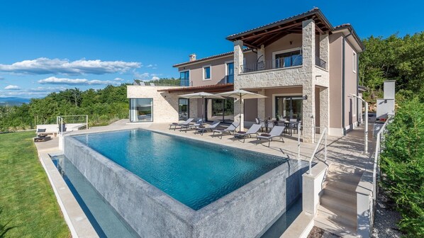 An infinity pool, pool loungers