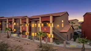 A multi-story hotel with balconies, a sandy ground, and a clear sky. - About Time Oasis Mesquite Vacation Rental with Private Balcony with $510 of free daily activities (Mesquite)