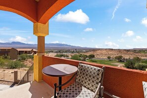 A balcony with a table and chair, overlooking a mountainous landscape with a clear sky. - About Time Oasis Mesquite Vacation Rental with Private Balcony with $510 of free daily activities (Mesquite)