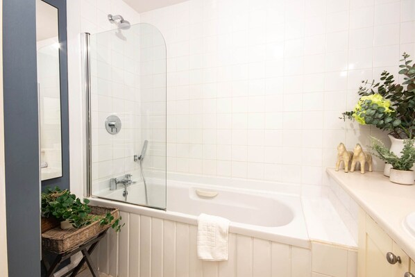 A bathroom with a glass shower enclosure, a white bathtub, and a sink with decorative items. - Windrush Lake 87, The Retreat (P) - Lakeside Lodge, On-site Facilities, Sleeps 6 (South Cerney)