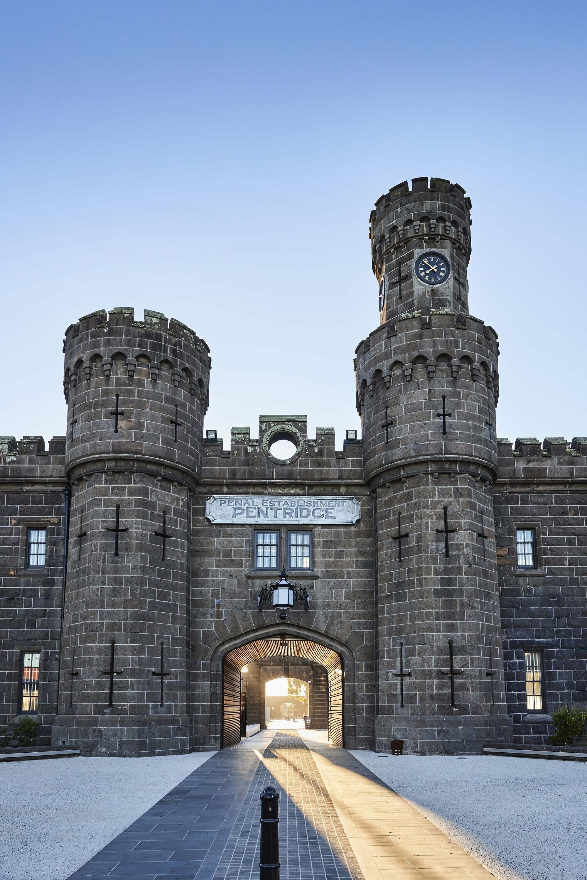 A historic building with two prominent towers and a central entrance.