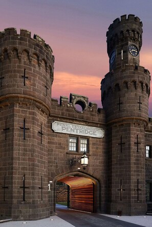 A historic building with a sign reading "Penal Establishment Pentridge" and a clock tower. - Adina Apartment Hotel Melbourne Pentridge (Coburg)