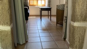 A staircase leading to a room with a window, a table, and a lamp. - Typical Cévenol Mazet with magnificent view (Saint jean du gard)